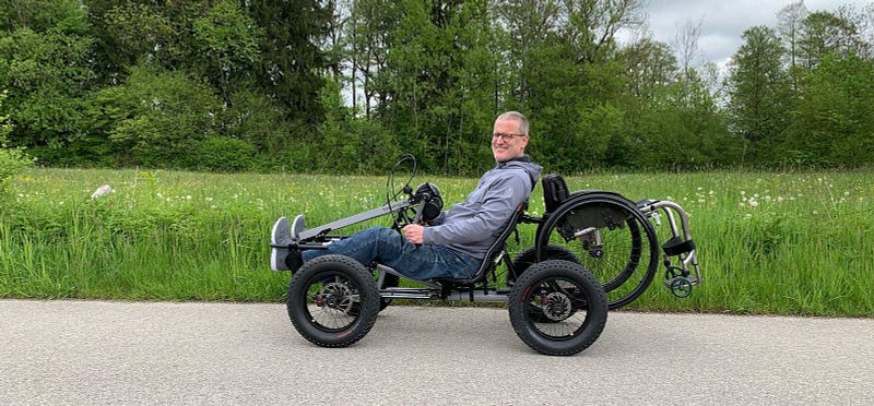 User enjoying the Manul 4x4 Handquad in a natural setting