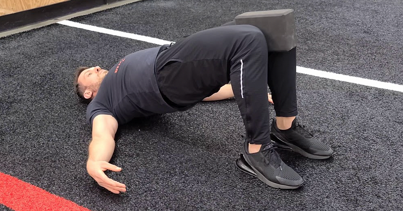 Glute bridge exercise focusing on adductors