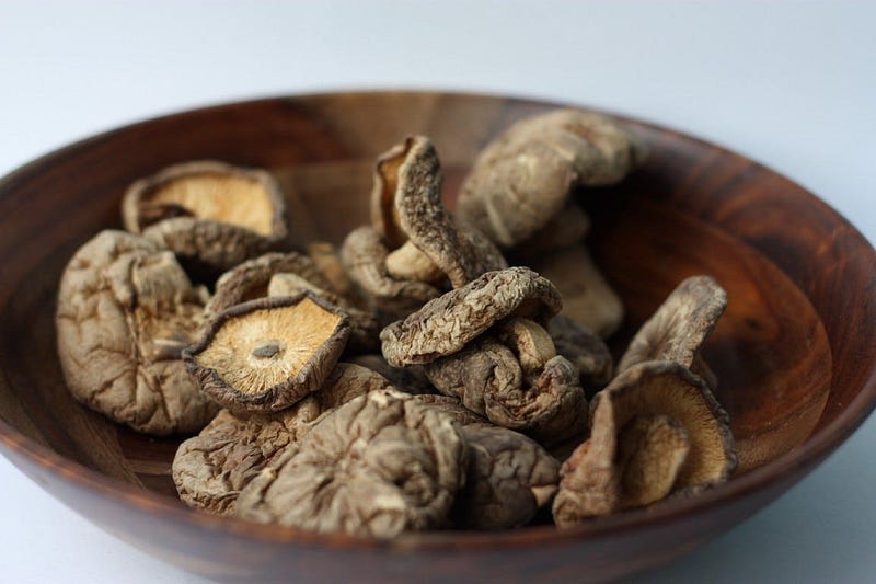 Shiitake mushrooms on a wooden cutting board