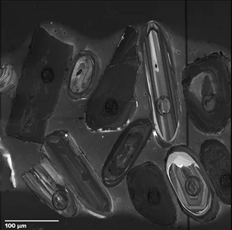 Microscopic view of zircon crystals revealing age diversity.