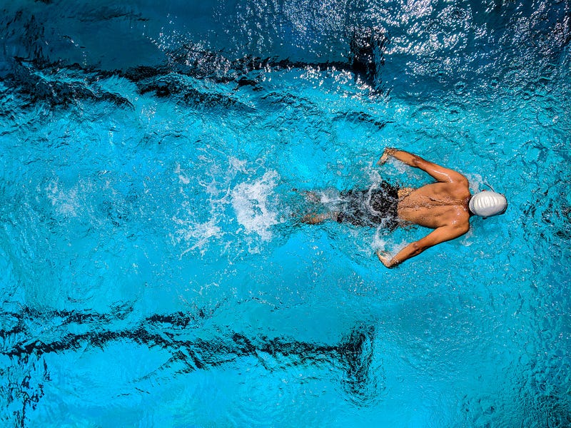 Teenagers embracing teamwork in swimming